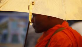 Buddhist Monk wearing Umbrella, Cambodia
